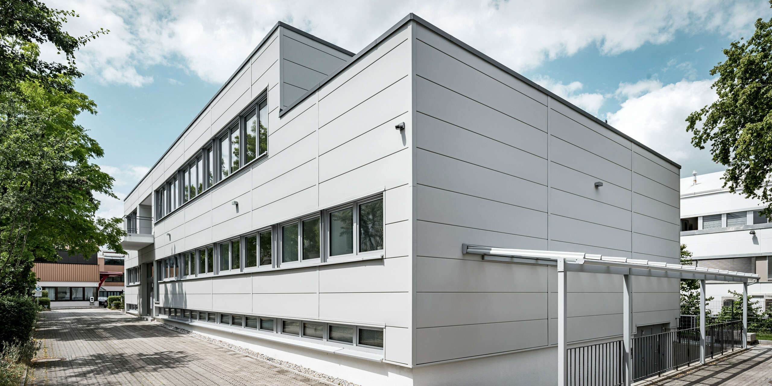 Boční pohled na objekt opláštěný fasádními lamelami PREFA Siding v barvě P.10 prefa bílé.