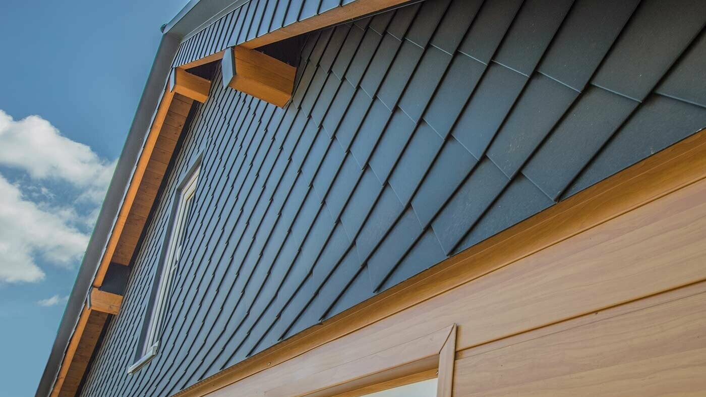Ztvárnění fasády za použití PREFA Sidings v designu světlé dřevo a obklad štítu PREFA fasádními šablonami 20 × 20 v antracitové barvě.