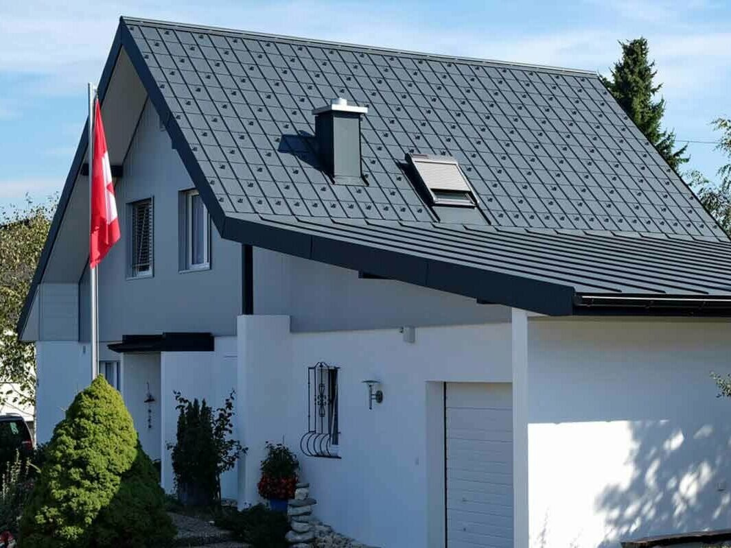 Dům s garáží po sanaci střechy za použití PREFA falcovaných střešních tašek antracitové barvy